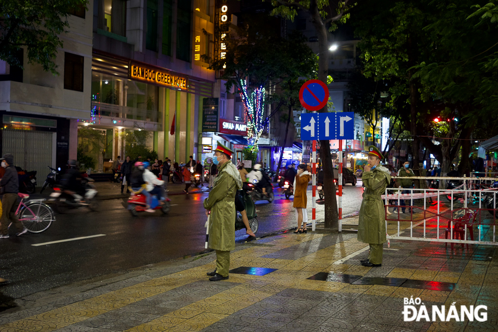 Police officers being on duty to ensure traffic order and safety along streets on Christmas Eve