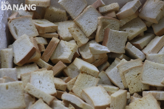 After baking, bread cakes are cut into small cubes