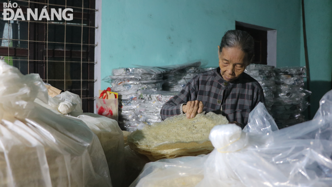 Finished rice papers are wrapped in paper and plastic to preserve