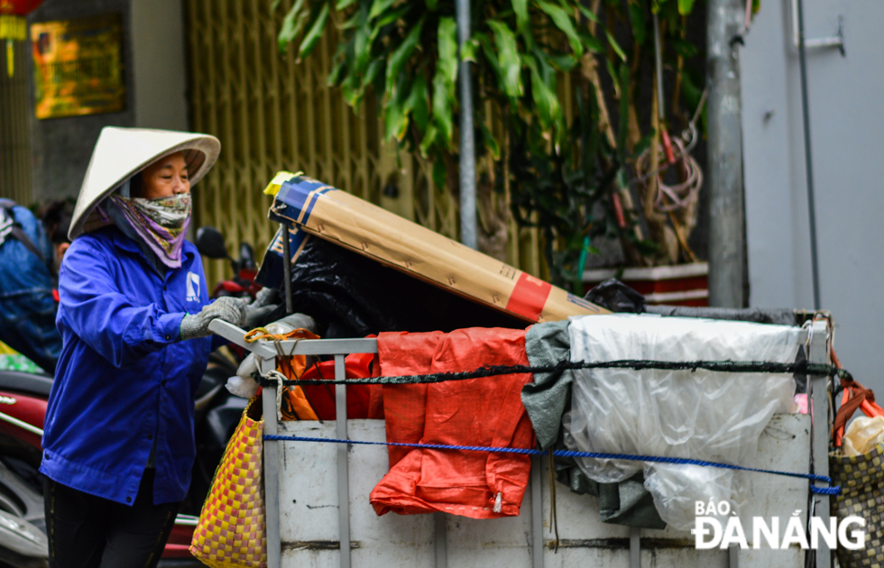 A trash collector working under cold weather conditions