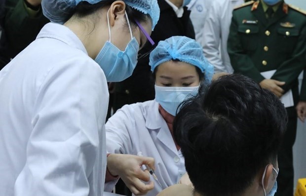 The first human trial of COVID-19 vaccine Nanocovax begins in Vietnam on December 17 with the first three volunteers, receiving injections at the Military Medical Academy. (Photo: VNA)