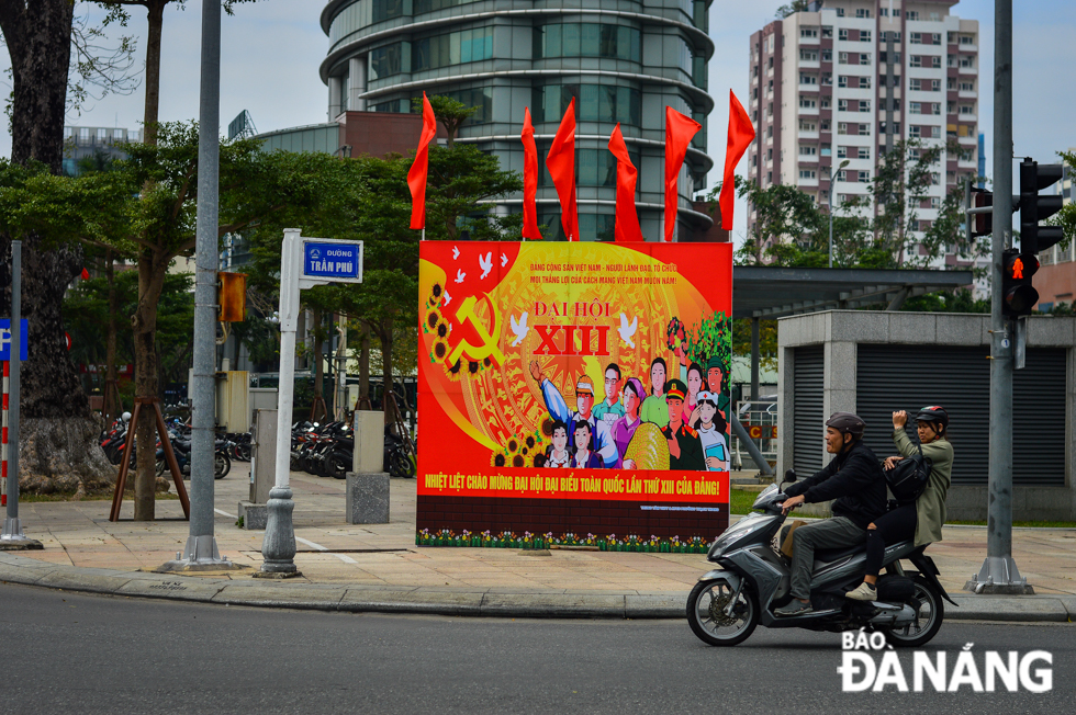 A big-sized vivid panel with welcoming words towards the 13th National Party Congress is placed at the intersection of Tran Phu and Quang Trung streets