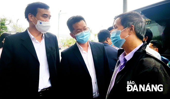 Secretary Quang (centre) and Chairman Chinh (left) giving spiritual encouragement to a group member