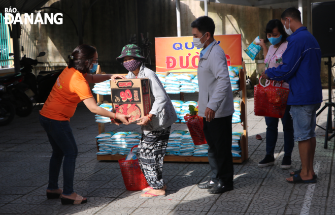 Poor people receiving in-kind gifts at the charity market