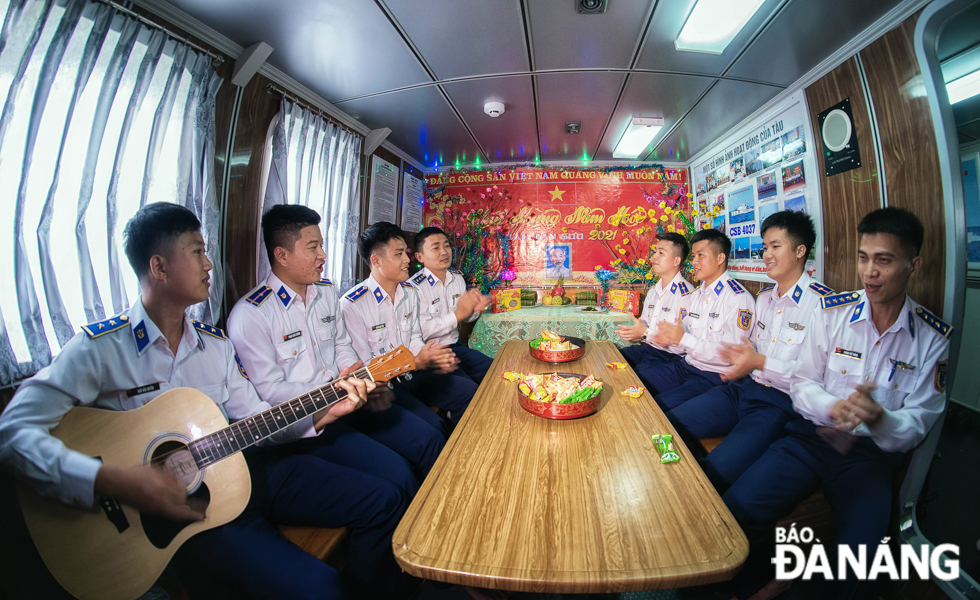 Coast guards onboard together singing songs to with cheerful rhythms to welcome in Lunar New Year