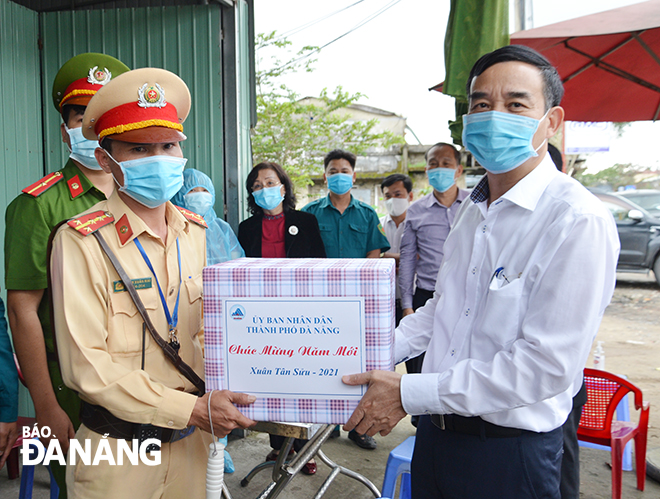 Da Nang People's Committee Chairman Le Trung Chinh presenting gifts to the staff on duty at a checkpoint set up on the National Highway No 14B ( near the Da Nang-Quang Ngai Expressway).