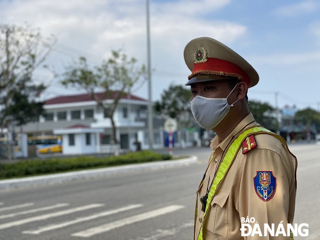   A local traffic police officer bing on duty at a checkpoint on Tran Dai Nghia Street