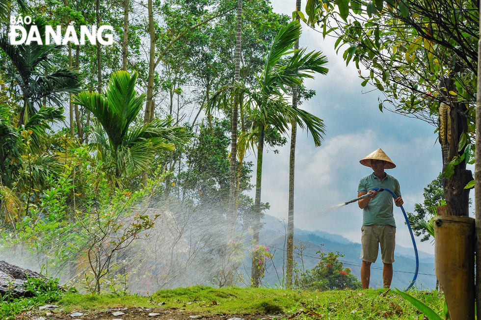 A staff of the tourist site watering flowers and plants here