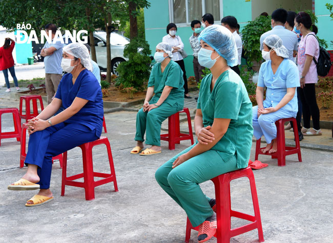 The medical staff waiting for their turns to get vaccinated whilst keep a safe distances from others