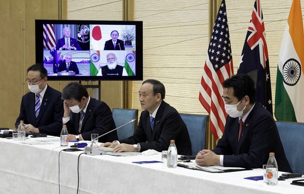 Japanese Prime Minister Yoshihide Suga (second, right) speaks at the virtual Quad summit on March 12 (Photo: AFP/VNA)