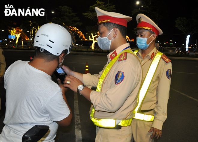 A motorcycle driver undergoes a breathalyser test