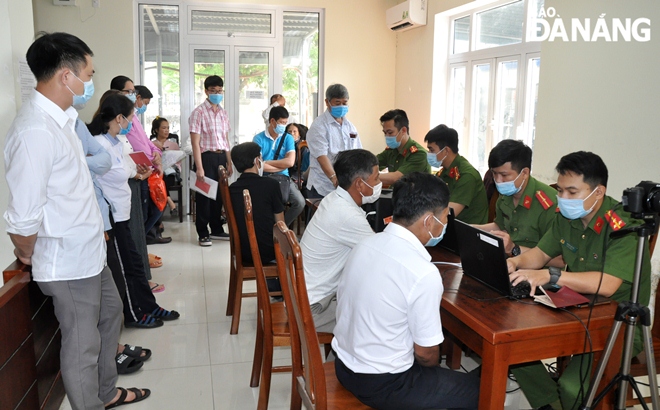 A scene of the Cam Le District one- stop shop handling registration forms for chip-based ID cards