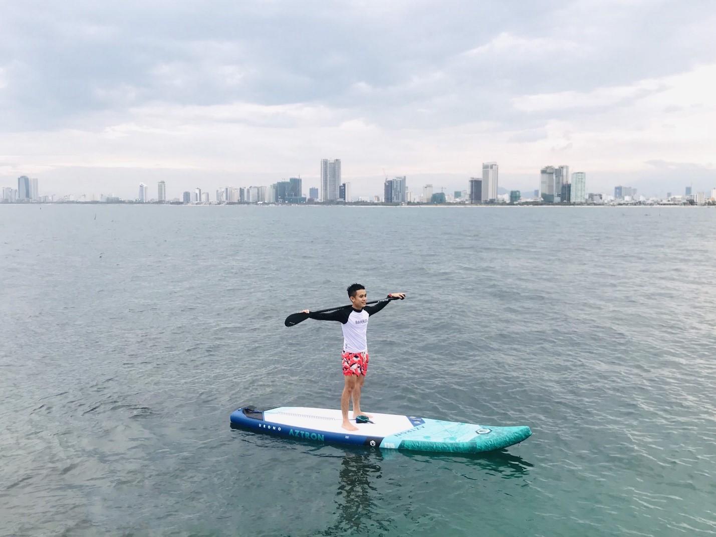 Mr Huynh Anh Vu standing up paddle board on the Man Thai Beach 