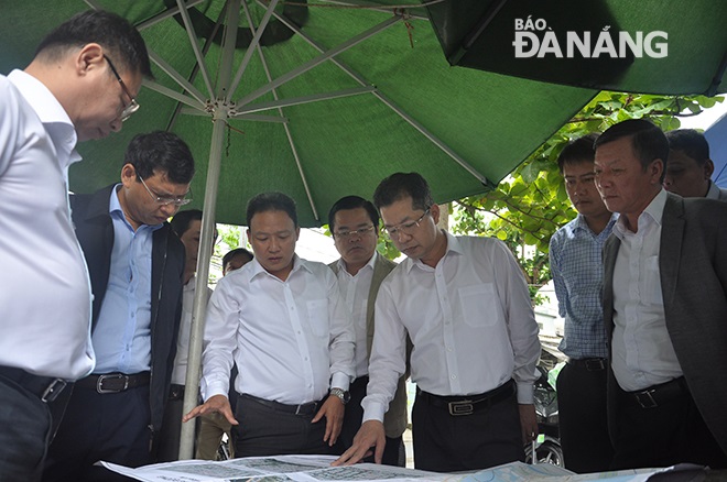 Secretary Quang (3rd right) listening to reports about road embellishment plans released by leaders of Hai Chau District, and …