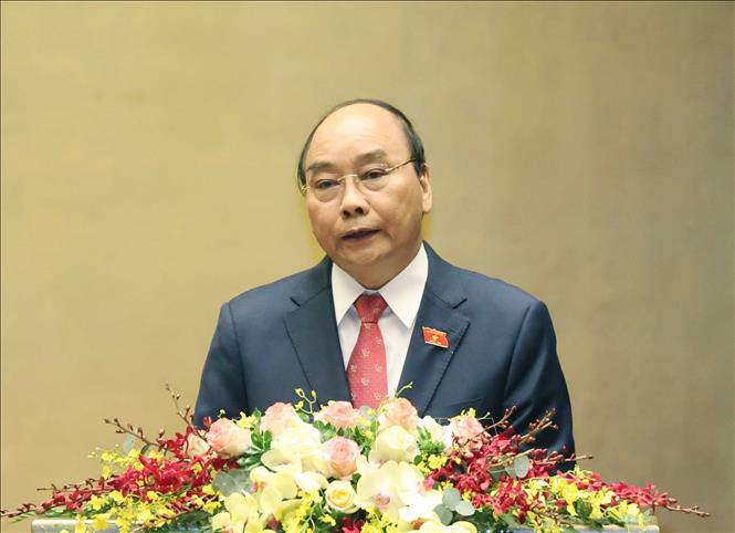 Thủ tướng Nguyễn Xuân Phúc trình bày Báo cáo tổng kết của Chính phủ nhiệm kỳ 2016-2021. Ảnh: Thống Nhất/TTXVN
