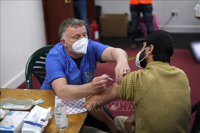 Nhân viên y tế tiêm vaccine ngừa COVID-19 cho người dân tại điểm tiêm phòng ở London, Anh ngày 23/3/2021. Ảnh: AFP/TTXVN