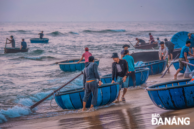 Fishermen hurriedly pulling coracles ashore after a night of fishing