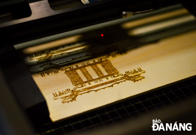 Images are printed onto sheets of natural wood via the laser engraving machine.