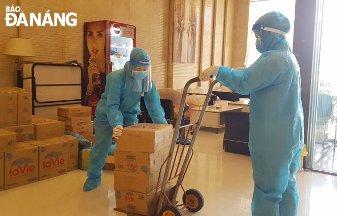 Medical staff preparing supplies of basic necessities for the quarantined