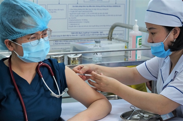 A medical staff of Nghệ An Province General Friendship Hospital receives COVID-19 vaccine shot on Tuesday. — VNA/VNS Photo Bích Huệ