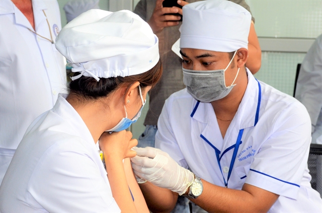 Medical staff at Sóc Trăng General Hospital in the southern province of Sóc Trăng receive COVID-19 vaccines on Monday. — VNA/VNS Photo Trung Hiếu