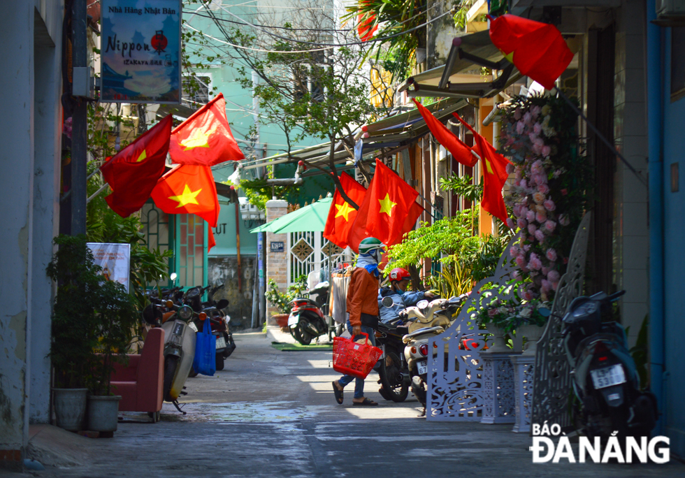 National flags are seen in an alley on Ly Thuong Kiet Street.