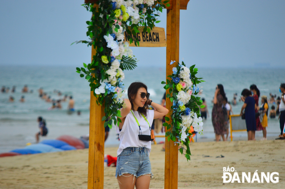 …and only take off the masks when posing for photos with eye-catching miniatures set up on beaches.