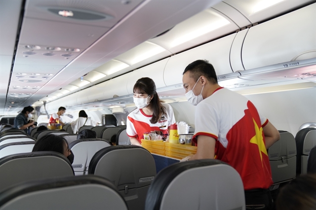 Vietjet flight attendants serve food and drinks to passengers on board. — Photo courtesy of Vietjet