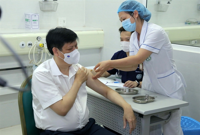 Vietnamese health minister Nguyễn Thanh Long receives the COVID-19 vaccine jab on Thursday at Bạch Mai Hospital in Hà Nội. — VNA/VNS Photo Hoàng Hiếu