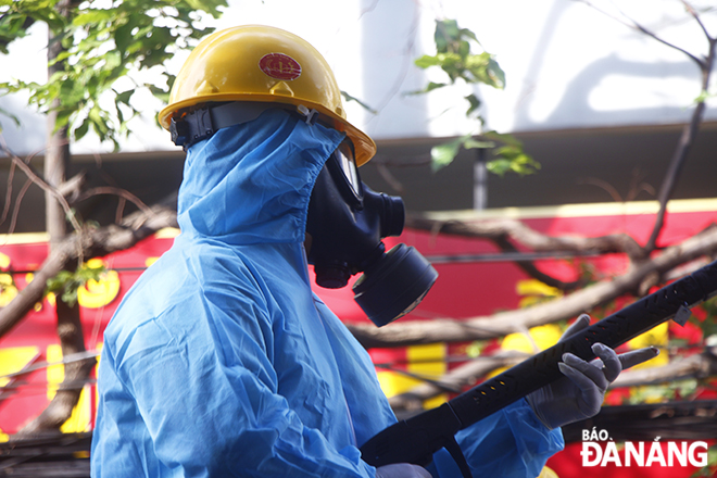 Staff who are conducting disinfectant sprays for the prevention of COVID-19 are fully equipped with personal protective equipment such as gas masks.