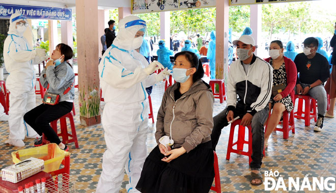 Nhân viên y tế tiến hành lấy mẫu xét nghiệm SARS-CoV-2 đối với trường hợp làm việc tại các cơ sở dịch vụ trên địa bàn quận Sơn Trà. (Ảnh chụp ngày 7-5)Ảnh: LÊ HÙNG