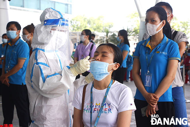 Medial workers took a combined throat and noise swab of all personnel working at the Da Nang Airport to test for COVID-19 on May 11. Photo: Xuan Dung