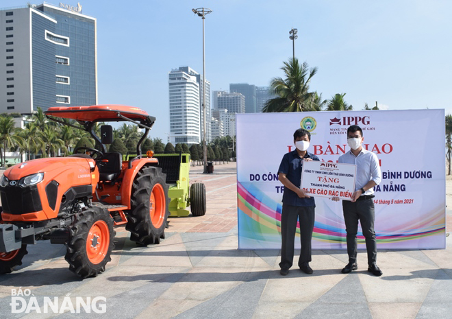 A IPPG representative (right ) hands over specialised beach cleaning vehicles to  the Da Nang Urban Environment Joint Stock Company. Photo: HOANG HIEP