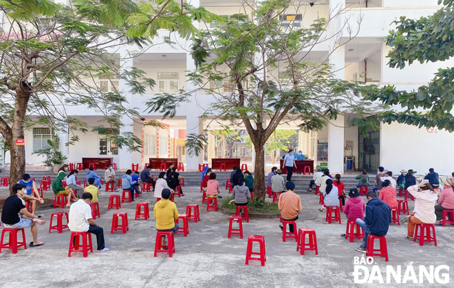 Medical staff arranged seating for the tested people to maintain a safe distance between them, as well as conduct temperature checks on them before taking their swab samples for COVD-19 testing. Photo:  TRONG HUNG