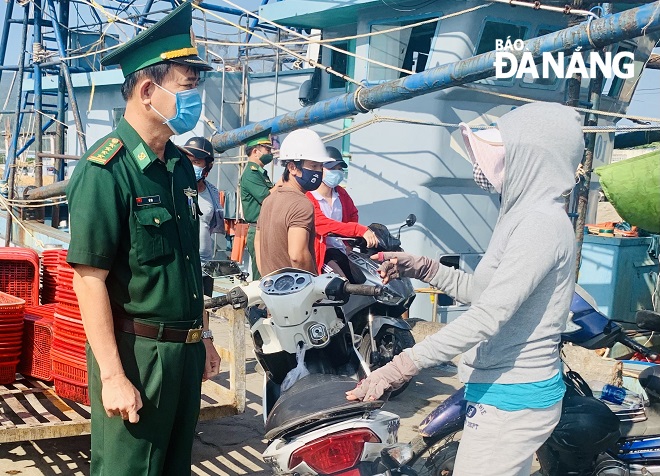 Đại tá Võ Tín động viên thăm hỏi ngư dân tại âu thuyền, cảng cá Thọ Quang, quận Sơn Trà. Ảnh: Q.H