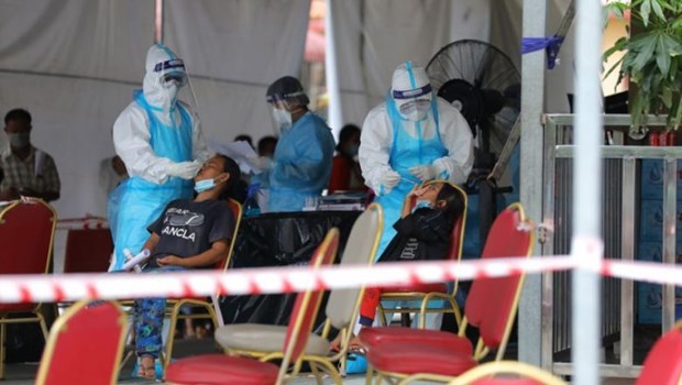 People have their samples taken for COVID-19 testing in Phnom Penh on May 23. (Photo: The Star)