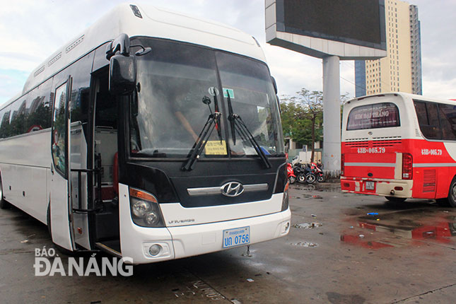 A tourist coach with a registration plate of Laos in the city