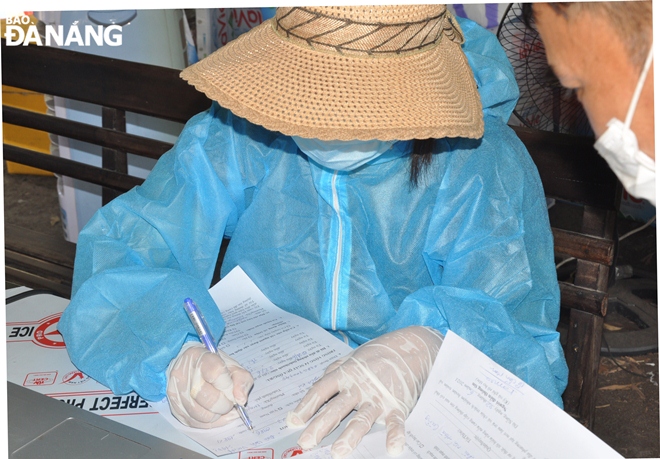 The hands of medical staff members on duty at a checkpoint based on Ta Quang Buu route are sweaty.