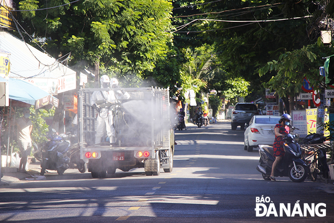 Small specialized vehicles are also mobilized to join the disinfection drive, July 14, 2021. Photo: Xuan Dung