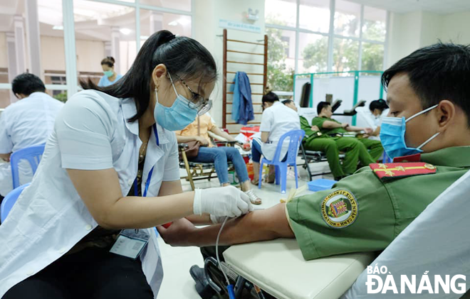 Public hospitals across the city are facing a dire shortage of blood for emergency and treatment amid the coronavirus rage. Police forces are seen participating in voluntary blood donation. Photo: LE HUNG