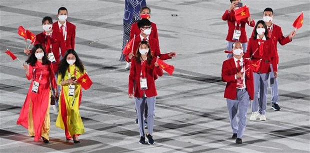Đoàn thể thao Việt Nam diễu hành tại lễ khai mạc Olympic Tokyo 2020 trên sân vận động Olympic ở Tokyo (Nhật Bản), ngày 23/7/2021. (Ảnh: AFP/TTXVN)