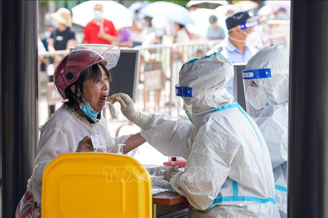 Nhân viên y tế lấy mẫu xét nghiệm Covid-19 cho người dân tại Dương Châu, tỉnh Giang Tô, Trung Quốc, ngày 7-8-2021. Ảnh: THX/TTXVN