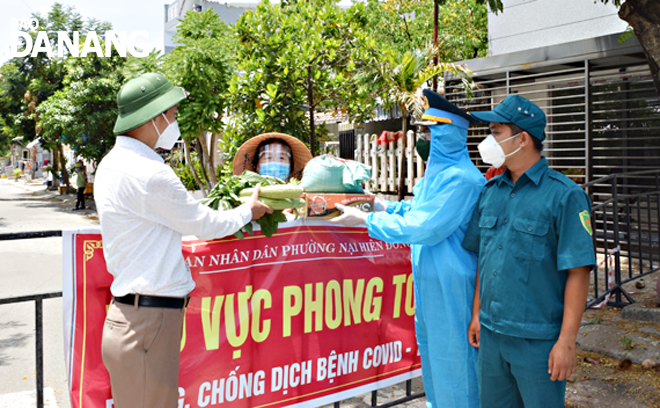 Các đơn vị mang thực phẩm và rau xanh vào tặng nhân dân khu vực phong tỏa của phường Nại Hiên Đông, quận Sơn Trà. Ảnh: HOÀNG HIỆP