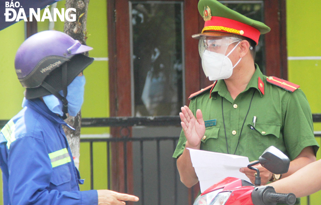 Son Tra District police check travel permit of a motorbike rider. Photo: DAC MANH.