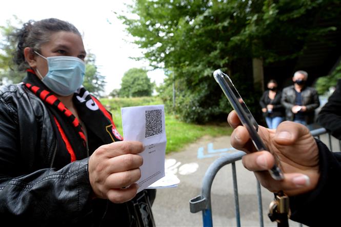  Xuất trình thẻ thông hành y tế trước khi vào xem một trận bóng đá tại sân vận động ở Rennes, Pháp, ngày 8/8/2021. Ảnh: AFP/TTXVN