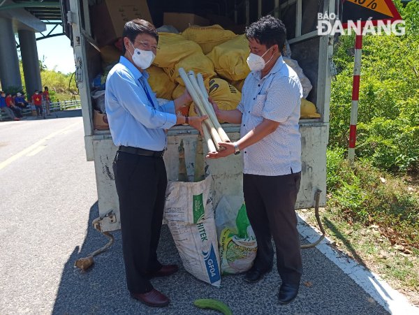 Chủ tịch Ủy ban MTTQ Việt Nam thành phố Ngô Xuân Thắng (bên trái) tiếp nhận ủng hộ do chính quyền và nhân dân huyện Tây Giang (tỉnh Quảng Nam) trao tặng. Ảnh: N.QUANG