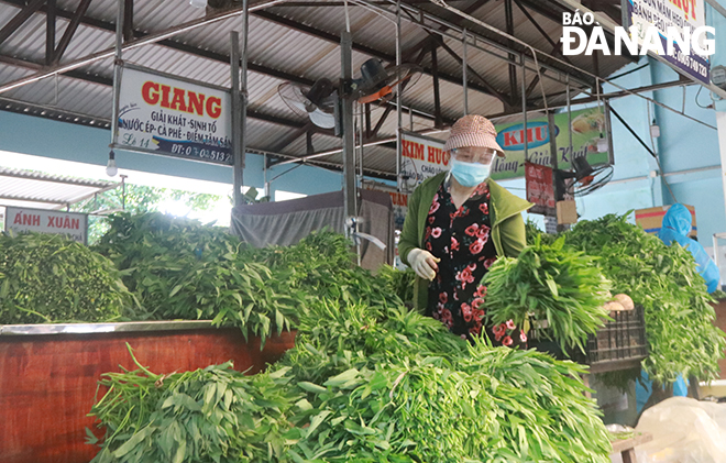  A representative of the authority of a local residential area is seen making the purchase of vegetables. Photo: DAC MANH