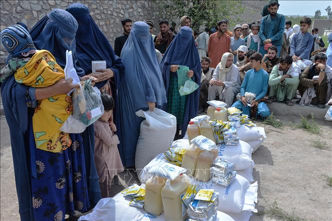 Người dân nhận hàng cứu trợ tại thành phố Jalalabad, Afghanistan ngày 20-4-2021. Ảnh: AFP/TTXVN