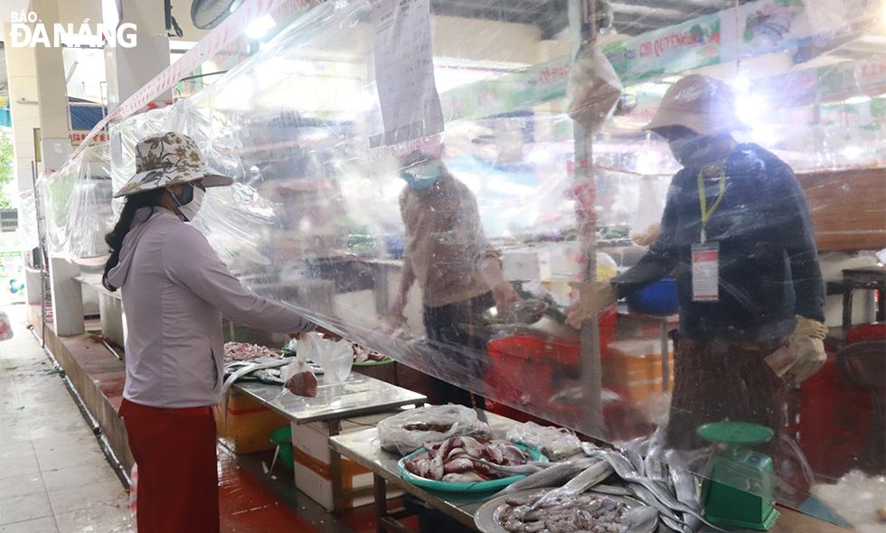 The food stalls in the Han Market are installing partitions to limit direct contact between sellers and buyers. Photo: DAC MANH