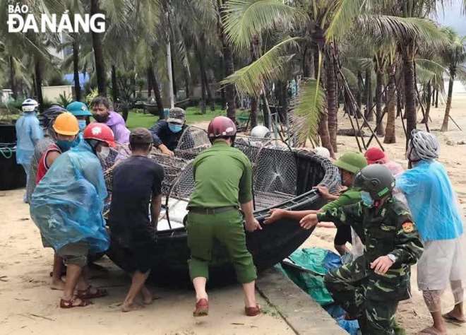 Police officers helping locals pull their basket boats ashore